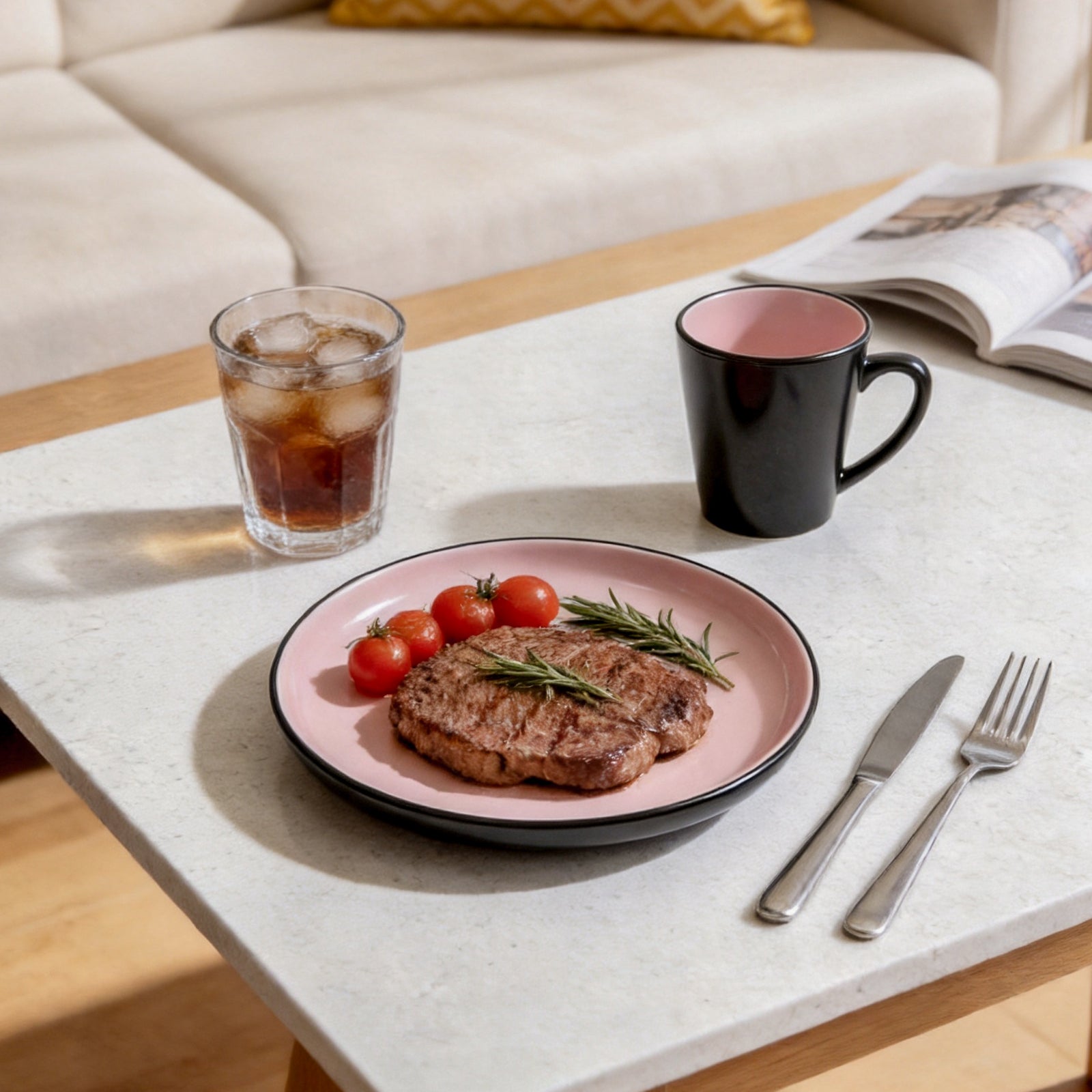 Plated steak with tomatoes on a table with a glass of iced tea and a mug.
