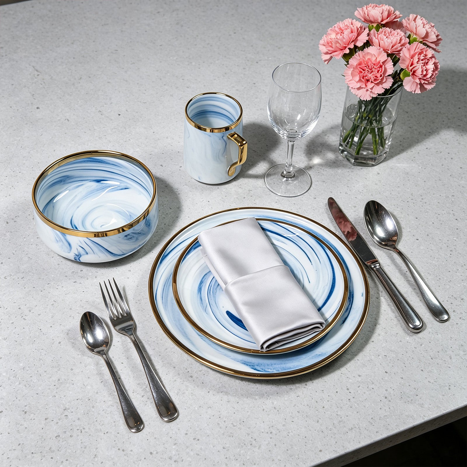 Top-down view of HomeVSS blue marble plates and mugs set on dining table