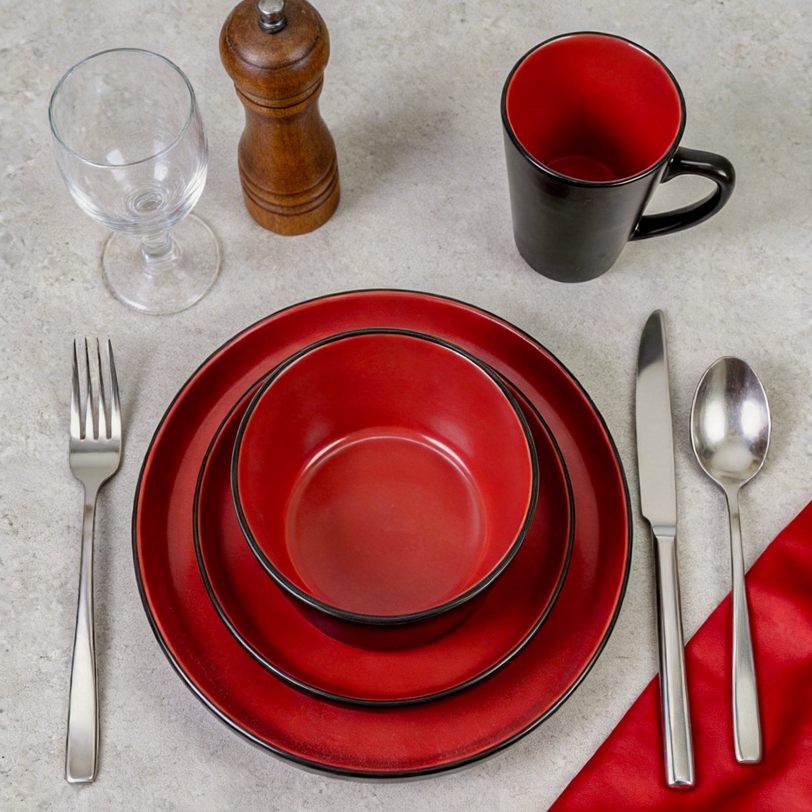 Elegantly plated food served on HomeVSS two-tone red ceramic dinner plates with high sides on a beautifully decorated dining table.