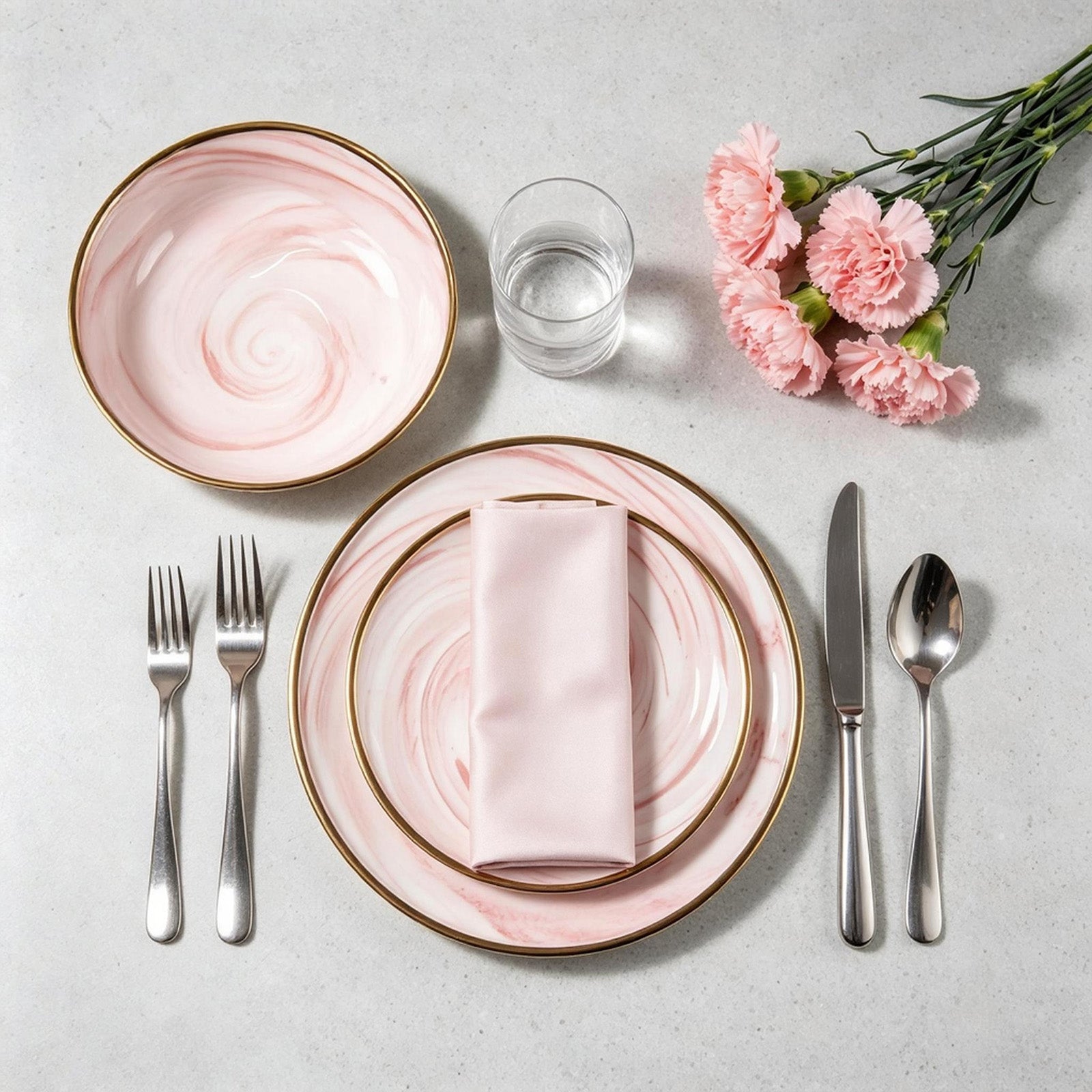 Aerial view of a HomeVSS pink plates and bowls place setting on a dining table