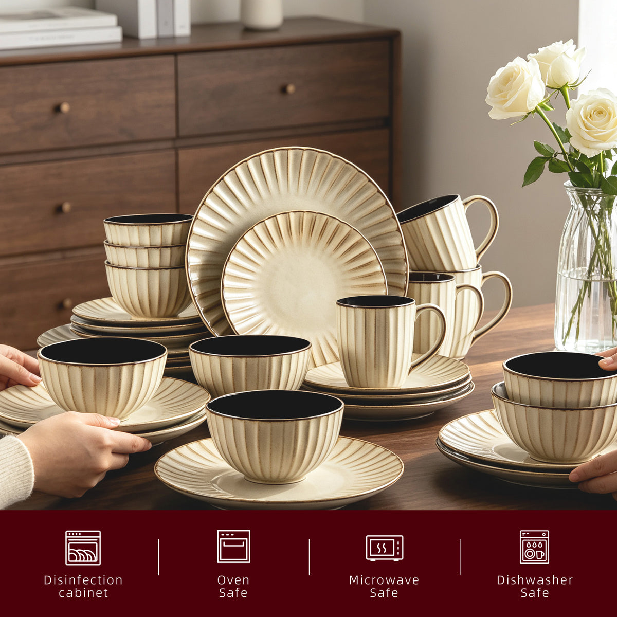 A coordinated ceramic dinnerware set arranged on a wooden table, including plates, bowls, and cups with a ribbed cream exterior and black interiors. Hands are holding some pieces, and a vase of white roses sits in the background.