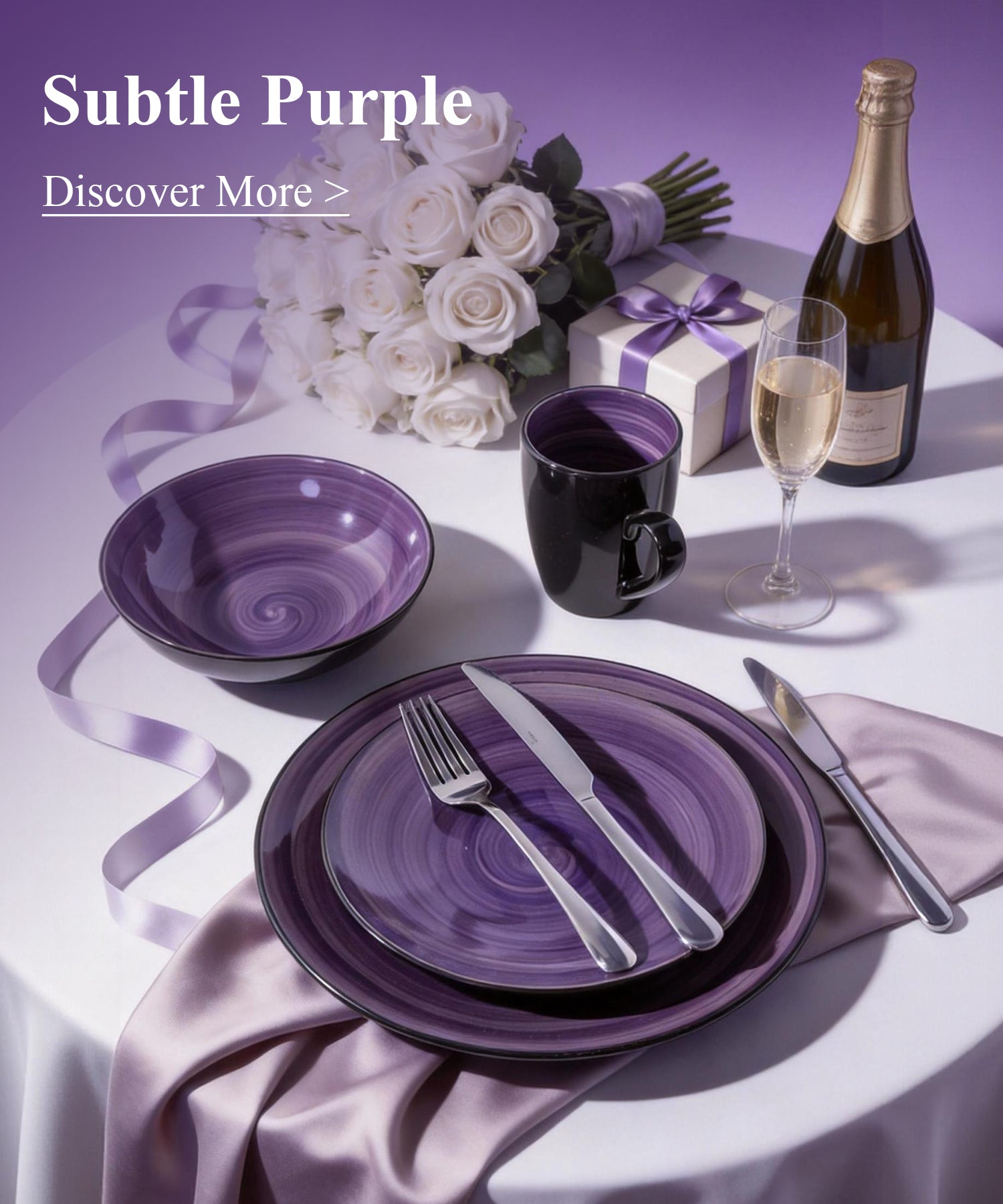 Table setting with purple plates, cups, and cutlery, accompanied by a bottle of champagne and flowers on a white tablecloth.