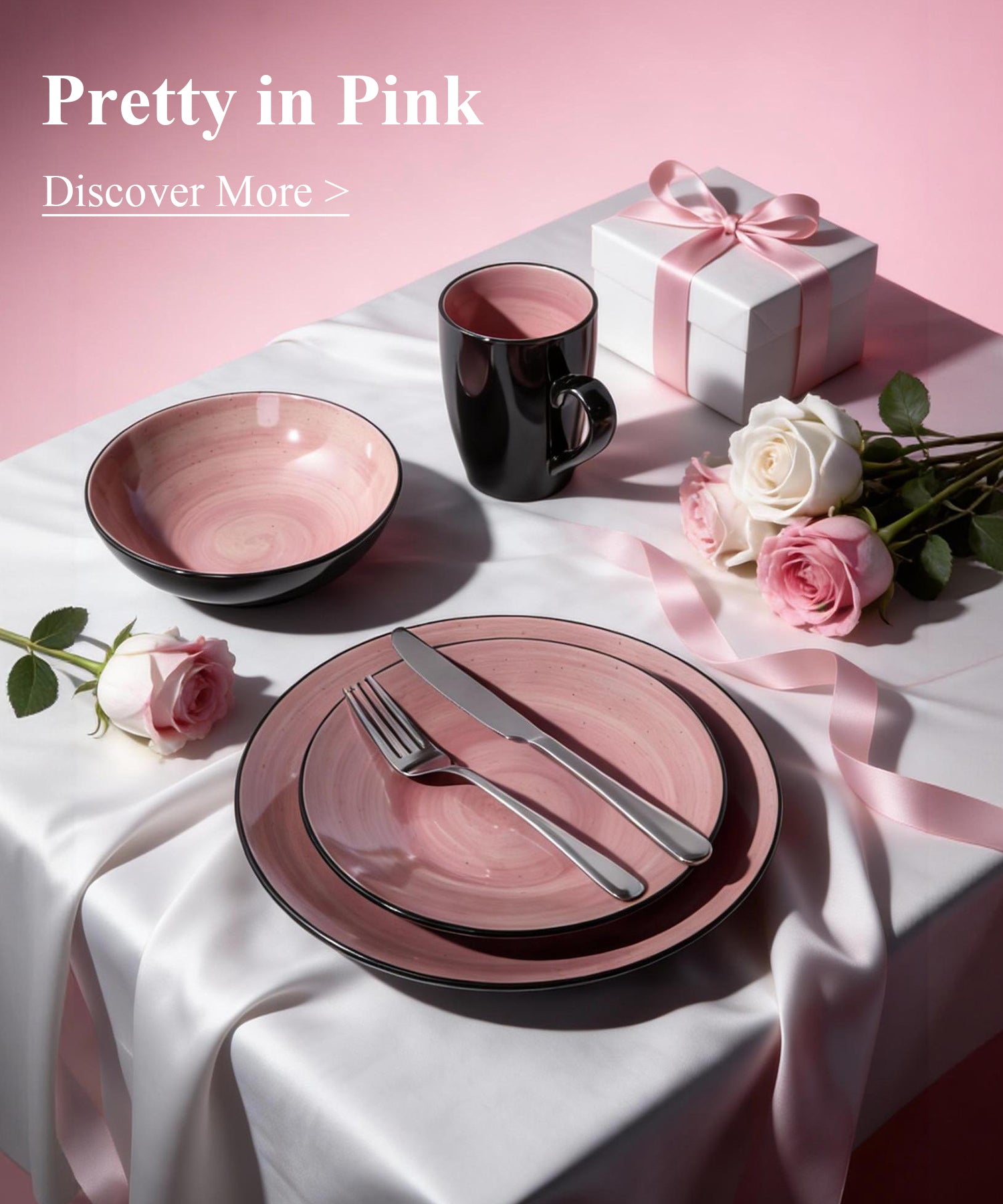 Pink ceramic tableware set with a gift box and flowers on a pink background.