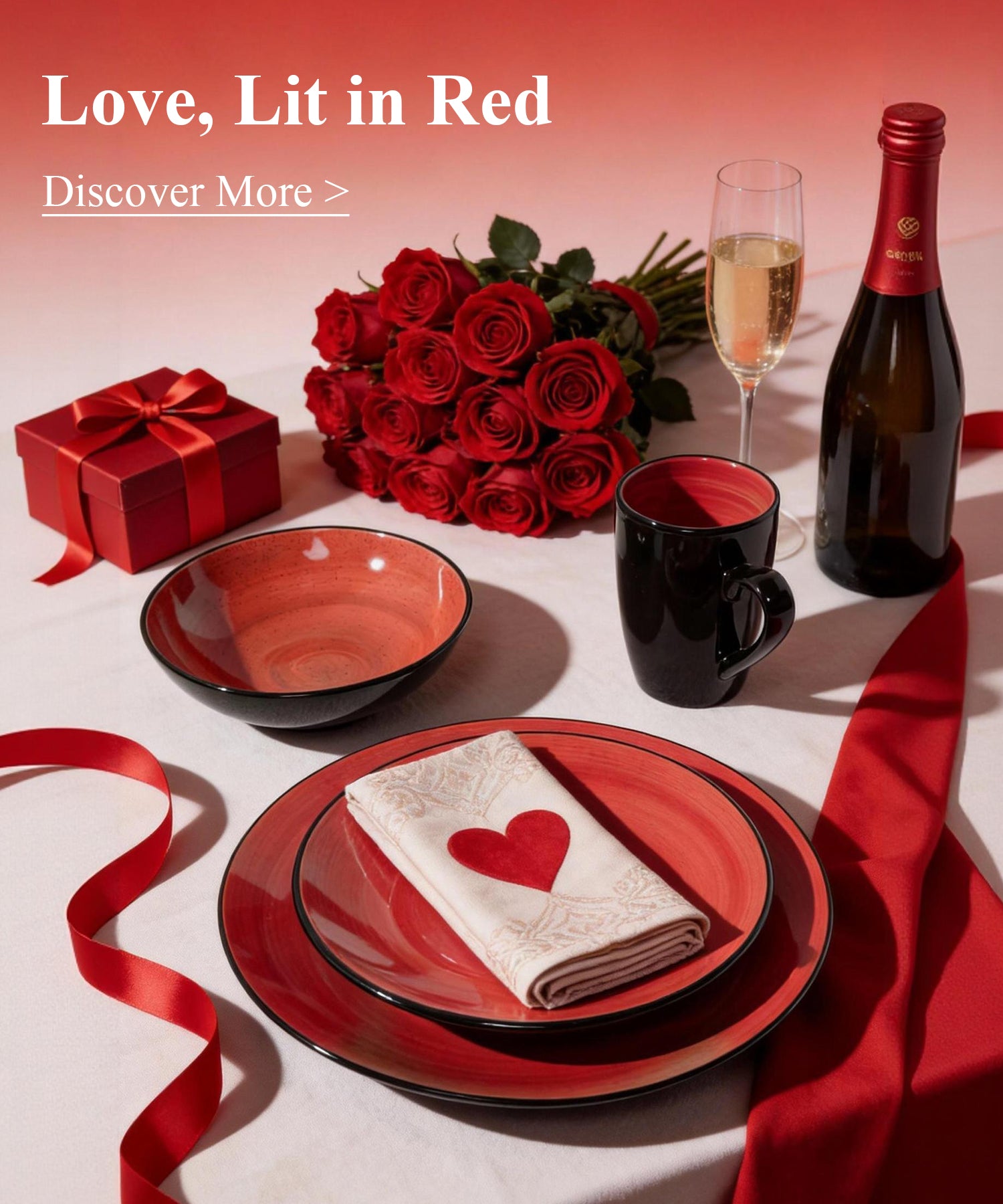 Valentine's Day-themed table setting with red roses, wine, and decorative items on a white tablecloth.